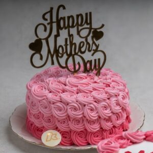 rose colored Cake with happy mothers day topper